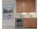 Elegant bar area with custom cabinetry, marble countertops, and beverage refrigerator at 701 Dartmouth Rd, Raleigh, NC 27609