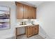 Stylish bar area featuring wooden cabinets, a quartz countertop, and modern fixtures, perfect for entertaining guests at 701 Dartmouth Rd, Raleigh, NC 27609