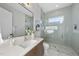Modern bathroom featuring a shower, vanity with sink, and neutral tones at 701 Dartmouth Rd, Raleigh, NC 27609