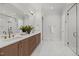 Bathroom with double vanity, wood cabinets, and a glass-enclosed shower at 701 Dartmouth Rd, Raleigh, NC 27609