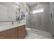 Modern bathroom featuring a frameless shower with stone floor and sleek vanity with elegant fixtures at 701 Dartmouth Rd, Raleigh, NC 27609