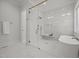 Luxurious bathroom featuring a glass shower, a soaking tub, and marble tiling at 701 Dartmouth Rd, Raleigh, NC 27609