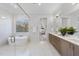 Modern bathroom with a soaking tub, dual vanities, and marble accents at 701 Dartmouth Rd, Raleigh, NC 27609