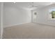 Empty bedroom featuring two large windows with white trim and neutral carpet flooring at 701 Dartmouth Rd, Raleigh, NC 27609