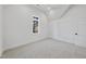 Bright bedroom with a window, neutral carpet, and white trim at 701 Dartmouth Rd, Raleigh, NC 27609