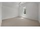 Bright bedroom features neutral carpet, window and modern ceiling fan with clean white walls at 701 Dartmouth Rd, Raleigh, NC 27609