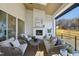 Inviting covered patio with a cozy fireplace, comfortable seating, and a ceiling fan, ideal for outdoor relaxation at 701 Dartmouth Rd, Raleigh, NC 27609
