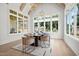 Bright dining room featuring large windows, hardwood floors, and modern light fixtures at 701 Dartmouth Rd, Raleigh, NC 27609