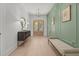 Elegant entryway with light wood floors, decorative wall paneling, a stylish console table, and an arched front door at 701 Dartmouth Rd, Raleigh, NC 27609