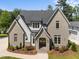 Beautiful two-story home with painted brick, white siding, lush landscaping, and inviting entrance at 701 Dartmouth Rd, Raleigh, NC 27609