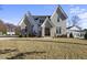 Charming two-story home with gray brick, stylish gables, and a welcoming front entrance at 701 Dartmouth Rd, Raleigh, NC 27609