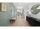 Bright foyer with hardwood floors, paneled accent wall, and elegant decor leads to open-concept living spaces at 701 Dartmouth Rd, Raleigh, NC 27609