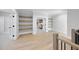 Upstairs landing with wood floors, wood shelves, and staircase with iron balusters at 701 Dartmouth Rd, Raleigh, NC 27609