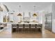 Open kitchen features a large quartz island with seating and pendant lights and abundant cabinet storage at 701 Dartmouth Rd, Raleigh, NC 27609