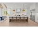 Bright kitchen with white cabinets, stainless steel appliances, a large island with seating, and hardwood floors at 701 Dartmouth Rd, Raleigh, NC 27609