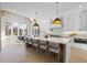 Open-concept kitchen featuring a large island with seating and stainless steel appliances, with an adjacent breakfast area at 701 Dartmouth Rd, Raleigh, NC 27609