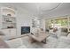 Elegant living room featuring a fireplace, built-in shelving and access to an outdoor area at 701 Dartmouth Rd, Raleigh, NC 27609