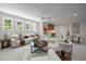 Spacious living room featuring ample seating, bar area, and three large windows for natural light at 701 Dartmouth Rd, Raleigh, NC 27609