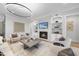 Bright living room with a fireplace, built-in shelves, and modern decor at 701 Dartmouth Rd, Raleigh, NC 27609
