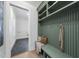 Well-organized mudroom with olive green shelving, a comfortable bench, and ample storage space, blending style with functionality at 701 Dartmouth Rd, Raleigh, NC 27609