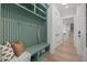 Hallway and mudroom features a cushioned bench, hooks, shelves, and hardwood flooring at 701 Dartmouth Rd, Raleigh, NC 27609