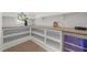 Well-organized pantry with ample shelving, wood countertop space, a beverage cooler, and natural light at 701 Dartmouth Rd, Raleigh, NC 27609