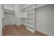 Bright and spacious walk-in closet with custom shelving and hardwood floors at 701 Dartmouth Rd, Raleigh, NC 27609