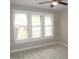 Bedroom with neutral walls, plush carpeting, and bright, shuttered windows at 7250 Nc 751 Hwy # 2101, Durham, NC 27707