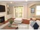 Bright living room features fireplace, hardwood floors, and French doors leading to a balcony at 7250 Nc 751 Hwy # 2101, Durham, NC 27707