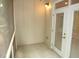 Screened in porch with paneled wall, ceiling light and a door to the exterior at 7250 Nc 751 Hwy # 2101, Durham, NC 27707