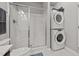 Bathroom with shower, toilet, and stackable washer/dryer at 108 Cullen Ct, Clayton, NC 27520