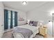 Cozy bedroom with a double bed and teal curtains at 108 Cullen Ct, Clayton, NC 27520