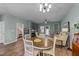 Open dining area with a wooden table and chairs, adjacent to living room at 108 Cullen Ct, Clayton, NC 27520