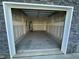Empty garage with concrete floor and overhead door at 108 Cullen Ct, Clayton, NC 27520