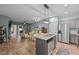 Open concept kitchen with island and view into living room at 108 Cullen Ct, Clayton, NC 27520