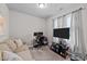 Home office with a sofa, desk and large TV at 108 Cullen Ct, Clayton, NC 27520