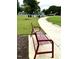 Red metal park bench along a walking path at 108 Cullen Ct, Clayton, NC 27520