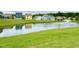 Neighborhood pond with fountain and houses reflecting in the water at 108 Cullen Ct, Clayton, NC 27520
