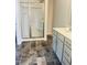 Bathroom showcasing walk-in shower, tile flooring and gray vanity at 321 Hopewell Branch Ct, Smithfield, NC 27577