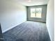 A carpeted bedroom features a window offering natural light and views at 321 Hopewell Branch Ct, Smithfield, NC 27577
