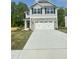 Charming two-story home featuring a stone facade and a spacious two-car garage at 321 Hopewell Branch Ct, Smithfield, NC 27577