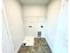 Laundry room includes tile floor, wire shelving and hookups at 321 Hopewell Branch Ct, Smithfield, NC 27577