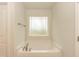 Bathroom featuring soaking tub with a frosted window for privacy and natural light at 347 Hopewell Branch Ct, Smithfield, NC 27577