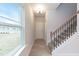 Welcoming entryway with natural light through a window, and staircase with decorative iron spindles at 347 Hopewell Branch Ct, Smithfield, NC 27577