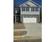 Two-story house with gray siding, stone accents, and a two-car garage at 347 Hopewell Branch Ct, Smithfield, NC 27577