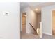 Hallway featuring stairs with wood banister and access to a carpeted bedroom and bathroom at 347 Hopewell Branch Ct, Smithfield, NC 27577