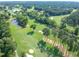 Aerial view of a golf course community with lush greenery and serene ponds at 102 Preston Pines Dr, Cary, NC 27513