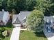 An aerial view of a charming two-story house with a tree and driveway at 102 Preston Pines Dr, Cary, NC 27513