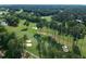 Aerial perspective of a golf course featuring fairways, sand traps, and ponds at 102 Preston Pines Dr, Cary, NC 27513