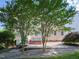 Backyard patio with hot tub and landscaping, providing a relaxing outdoor space at 102 Preston Pines Dr, Cary, NC 27513